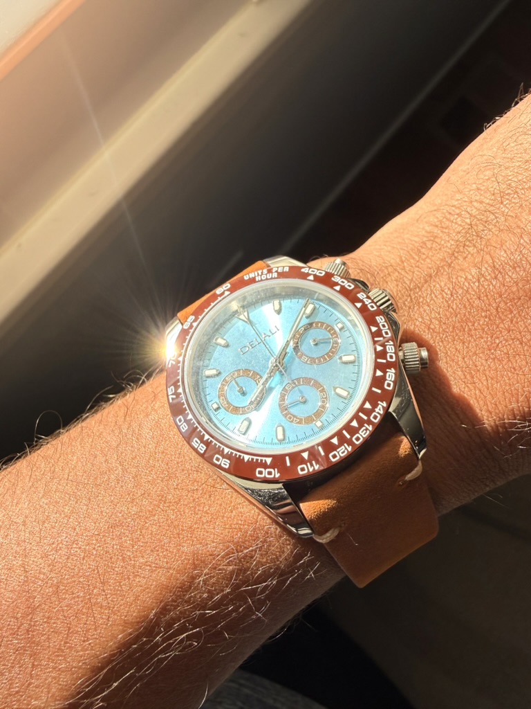 Amber Chronograph Homage — dial close-up in direct sunlight, worn on the wrist