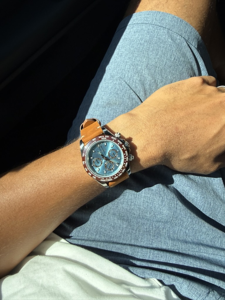 Amber Chronograph Homage — worn on the wrist, seated indoors